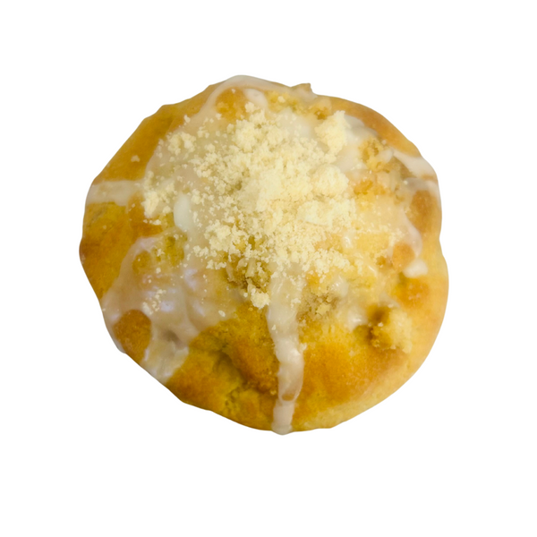 Round golden color cookie with icing and powdered sugar on a white background
