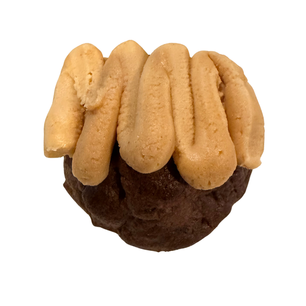 A single chocolate cookie with piped cream-colored frosting on top, isolated on a white background.
