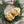 Two of The Duke chocolate chip walnut cookies rested within a green wreath with a red and white ribbon